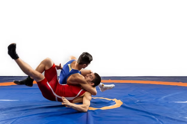 Two young men in blue and red wrestling tights wrestle
