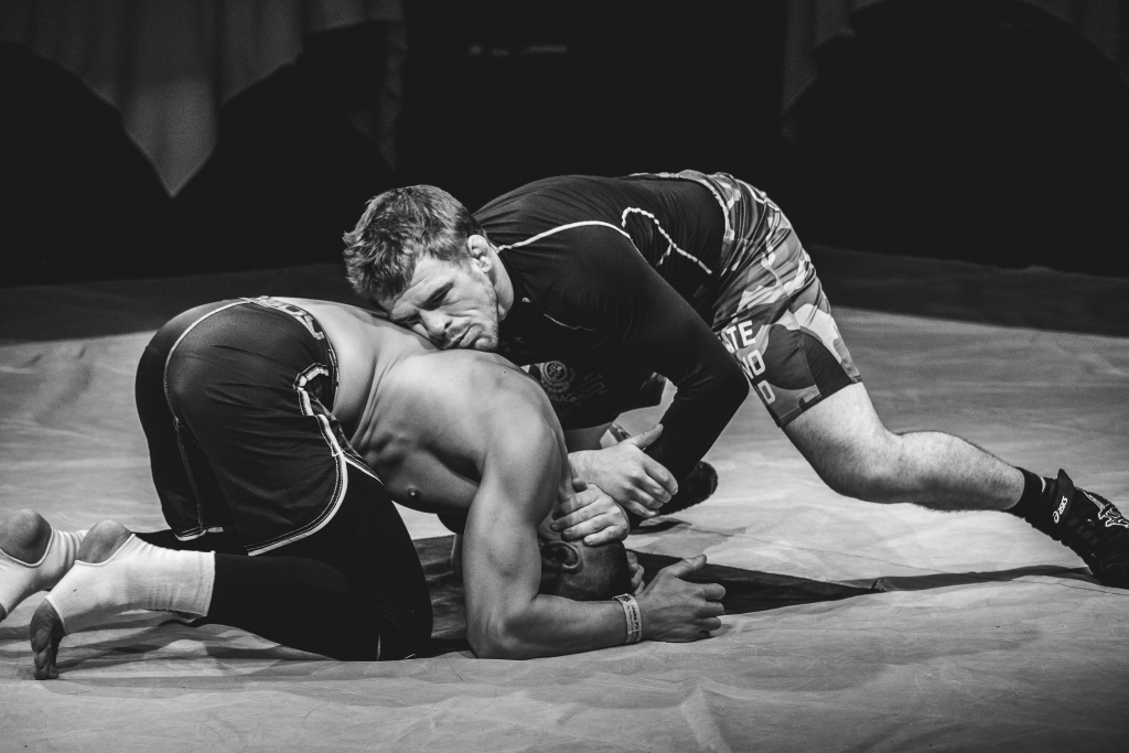 Two men wrestling on the carpet